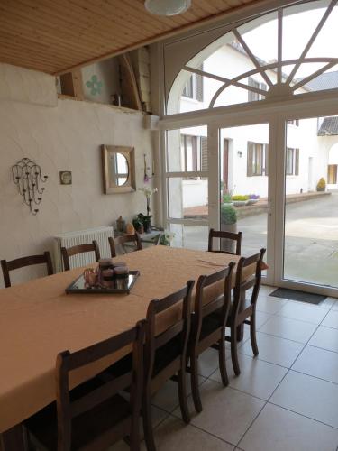 a dining room with a large table and chairs at De Aventurijn in Riemst