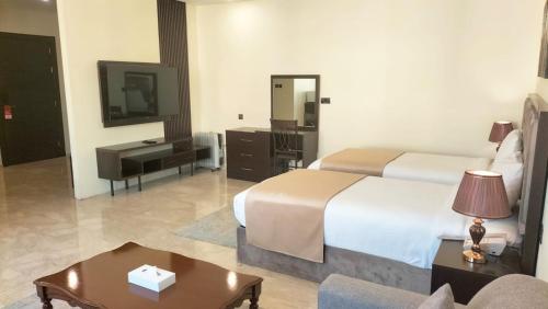 a hotel room with a bed and a television at City View Hotel- Managed by Arabian Link International in Kuwait