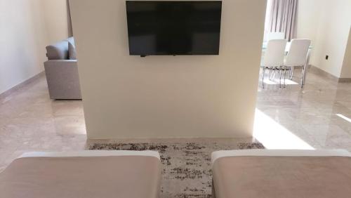 a living room with a flat screen tv on a wall at City View Hotel- Managed by Arabian Link International in Kuwait