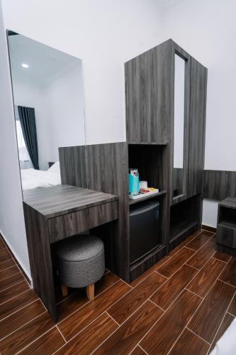 a room with a desk and a mirror at Sutera Damai Heritage in Kota Bharu