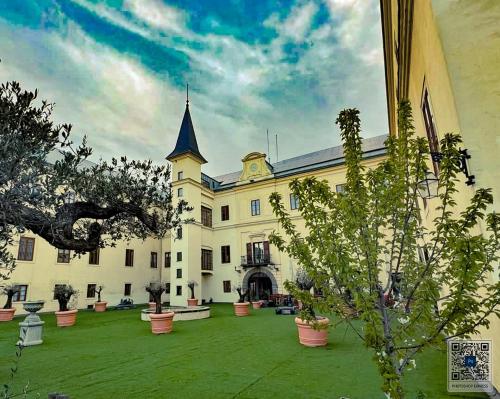 a large white building with a large yard with plants at Schloss Hubertendorf Apartment in Blindenmarkt