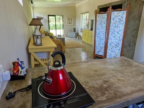 a red tea kettle on top of a kitchen counter at Blue Hills Lodge in Midrand