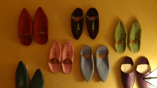 a bunch of shoes hanging on a wall at B&B Le Bonimenteur in Charleroi