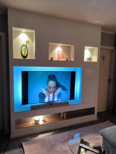 a large flat screen tv in a living room at Harz High End Fewo Exklusiv 5 Sterne DTV in Hahnenklee-Bockswiese