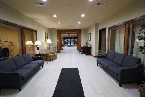 a living room with blue couches and a lobby at Super 8 by Wyndham Perryville in Perryville