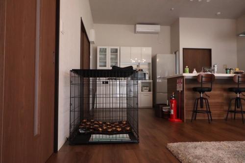 a bird cage with food inside of it in a kitchen at デコピンハウス in Hanamaki