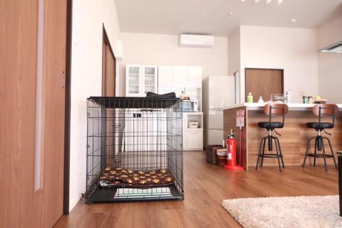 a bird cage in the middle of a kitchen at デコピンハウス in Hanamaki