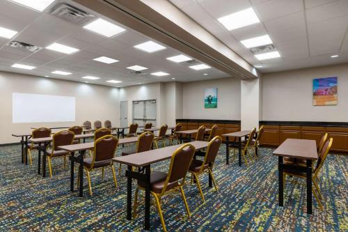 a conference room with tables and chairs and a whiteboard at Hampton Inn & Suites Woodward in Woodward