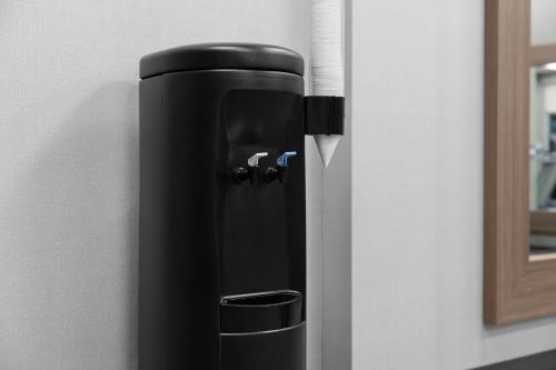 a black coffee dispenser on a wall at Courtyard by Marriott Orlando South/Grande Lakes Area in Orlando