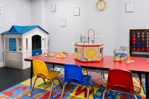 a table with four chairs and a toy house at Marriott's Manor Club at Ford's Colony in Williamsburg