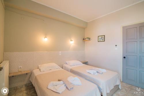 two beds in a room with towels on them at Bikakis Family Apartments in Kissamos