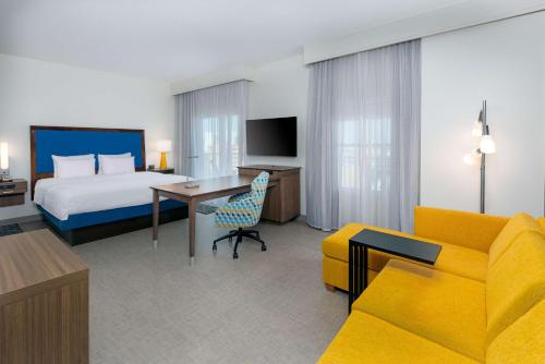a hotel room with a bed and a couch at Hampton Inn and Suites Clearwater Beach in Clearwater Beach