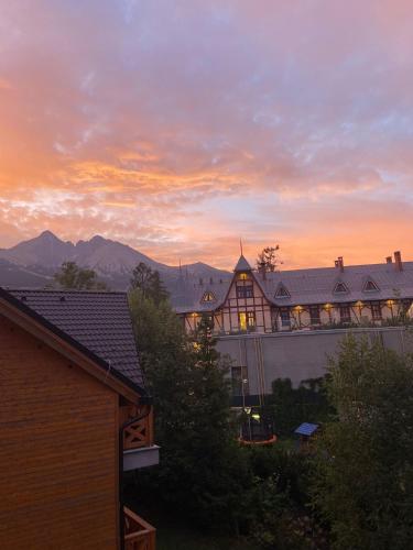 a view of a building with mountains in the background at Lomnica Lodge in Vysoké Tatry