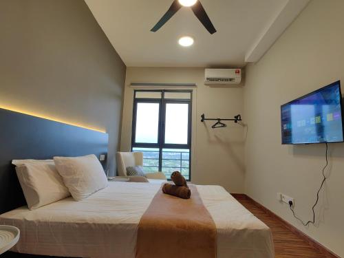 a bedroom with a large bed with a teddy bear on it at Near Airport K Avenue Family Room in Donggongon