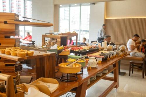 a buffet line with food on tables in a restaurant at Hilton Garden Inn Maceio in Maceió
