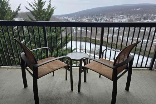 two chairs and a table on a balcony with a view at Country Inn & Suites by Radisson, Convention Center in Altoona