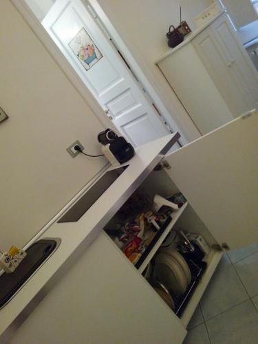 a kitchen with a counter top with an open refrigerator at B&B Mini Hotel Incity-close train station and port- in Salerno