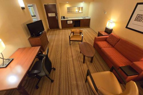 a living room with a couch and a table at Country Inn & Suites by Radisson, Convention Center in Altoona
