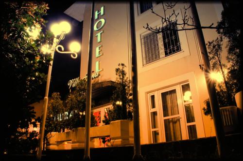 a building with a sign on the side of it at night at Hotel Vila Tina in Zagreb