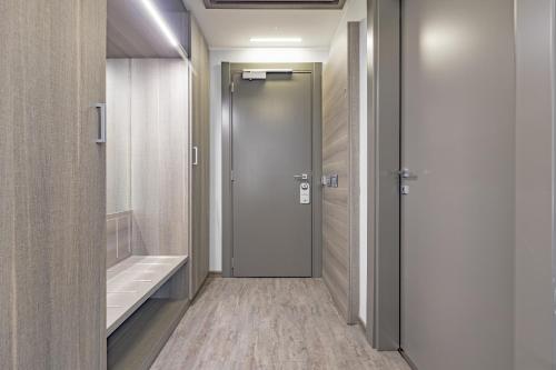 a bathroom with a door and a walk in shower at Just Hotel Saronno in Saronno