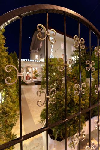 a view of a gate with a building in the background at Hotel Vila Tina in Zagreb