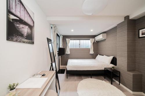 a small bedroom with a bed and a window at MX House - Cozy APT Stay in Ikebukuro Tokyo, with Direct Access to Shinjuku & Shibuya in Tokyo