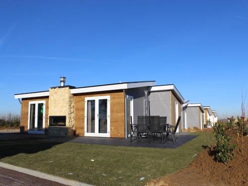 a small house with a patio and a grill at Stylish Villa in Bemelen in Bemelen