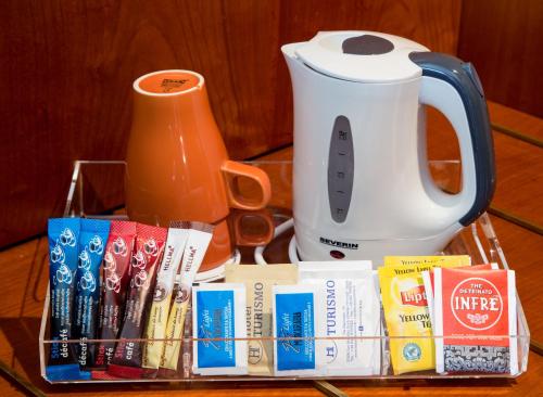 a tray filled with books and a jug of juice at Best Western Hotel Turismo in San Martino Buon Albergo