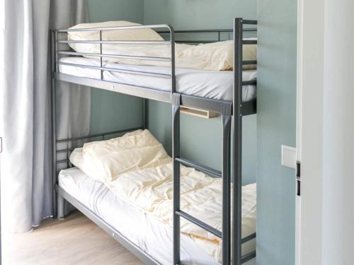 a bunk bed room with two bunk beds at Bungalow in Netherlands with Garden Terrace in 's-Gravenzande
