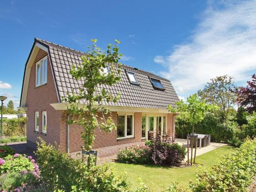 a brick house with a gambrel roof at Holiday Home in Noordwijk with Sunny Garden in Noordwijk aan Zee