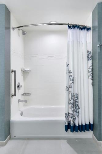 a bathroom with a tub and a shower curtain at Residence Inn by Marriott Lynchburg in Lynchburg
