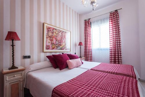 a bedroom with a large bed and a large window at Singular Corral de San José in Seville