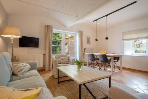 a living room with a couch and a table at Gut Oehe in Maasholm