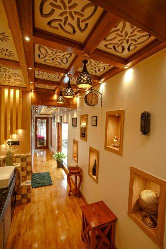 a large living room with wooden ceilings and wooden floors at Dreams Spectrum Luxury houseboat in Alleppey