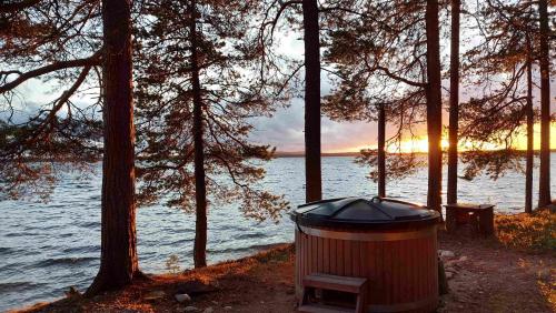 a trash can sitting next to a body of water at Porotieva in Posio