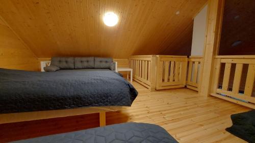 a bedroom with a bed in a wooden cabin at Porotieva in Posio