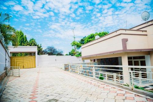 a building with a yellow door and a patio at Comfort away from home 1 in Mutanga