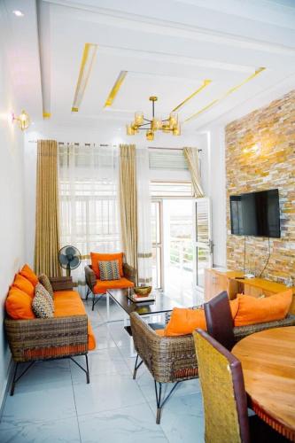 a living room with couches and a table and a tv at Comfort away from home 1 in Mutanga