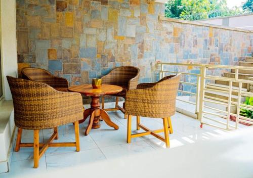 a patio with a table and chairs on a balcony at Comfort away from home 1 in Mutanga