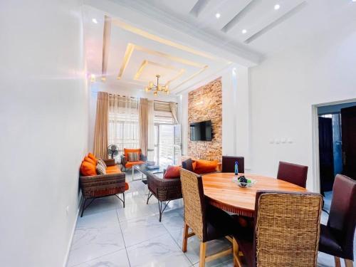 a dining room and living room with a table and chairs at Comfort away from home 1 in Mutanga