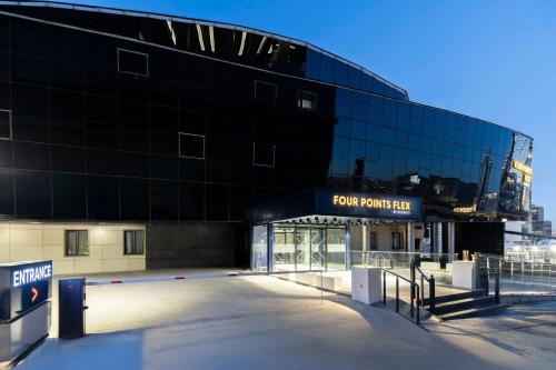 a building with a parking lot in front of it at Four Points Flex by Sheraton Ankara Cukurambar in Ankara