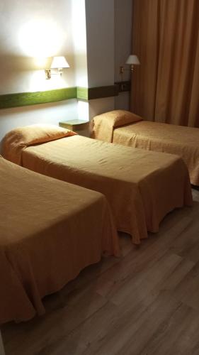 a hotel room with two beds in a room at Eurohotel in Piacenza