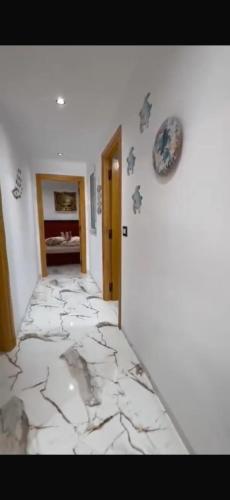 a hallway with a marble floor in a room at The Happy House in Kelibia