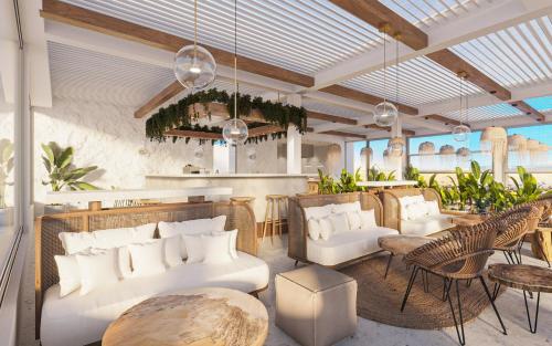 a restaurant with white couches and chairs and tables at Sirines Luxury Hotel & SPA- Adults Only in Rethymno Town