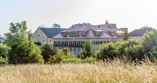 a large building in the middle of a field at Hotel Stiegl-Gut Wildshut in Wildshut