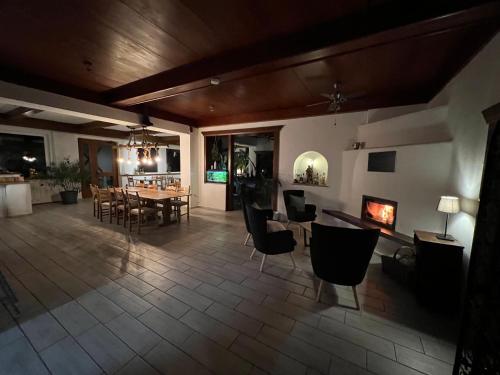 a living room with a fireplace and a table and chairs at Bergbude in Oberferlach