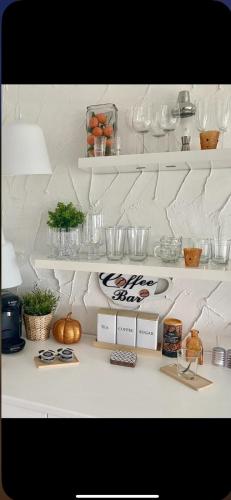 a white counter with bowls and other items on it at Seaview Cottage on the Island in Millbay