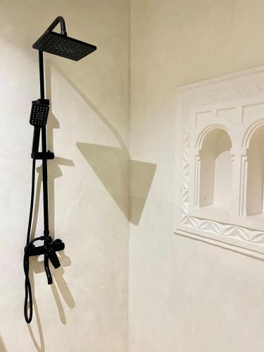 a camera on a tripod in a room with a mirror at Stopover Guest House and Restaurant in Lamu