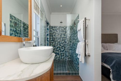 a bathroom with a sink and a shower at Island lifestyle on the water in Knysna