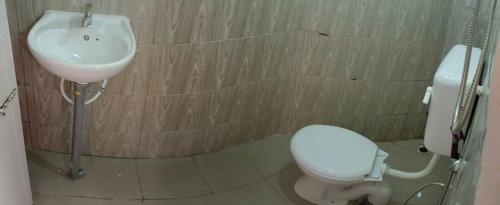 a small bathroom with a sink and a toilet at Perhentian Alia guest house in Perhentian Island